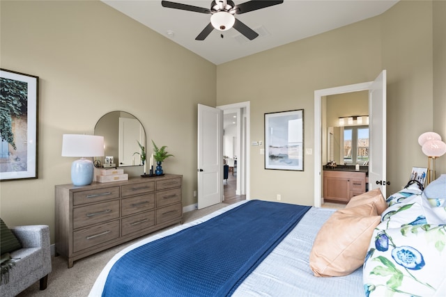 carpeted bedroom with ceiling fan and connected bathroom