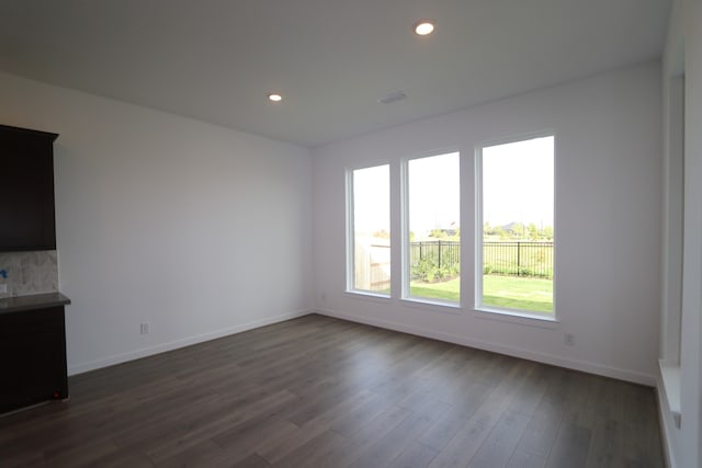 unfurnished living room with dark hardwood / wood-style floors