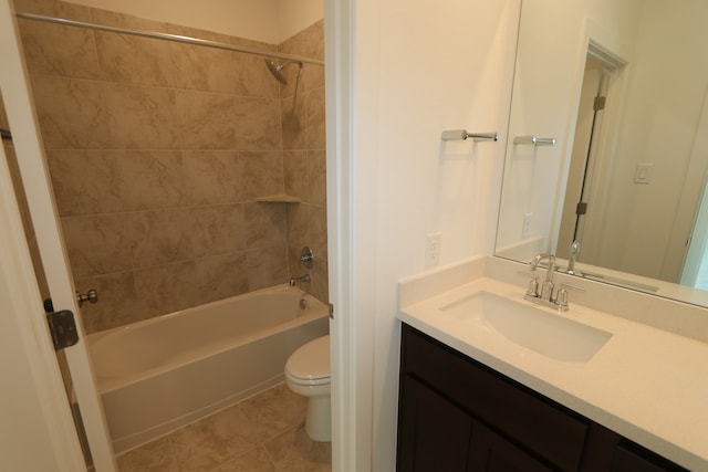 full bathroom with vanity, tile patterned flooring, tiled shower / bath, and toilet