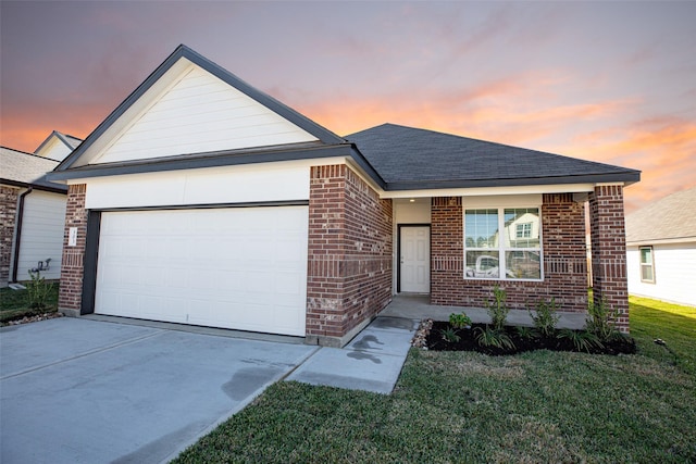 single story home featuring a yard and a garage