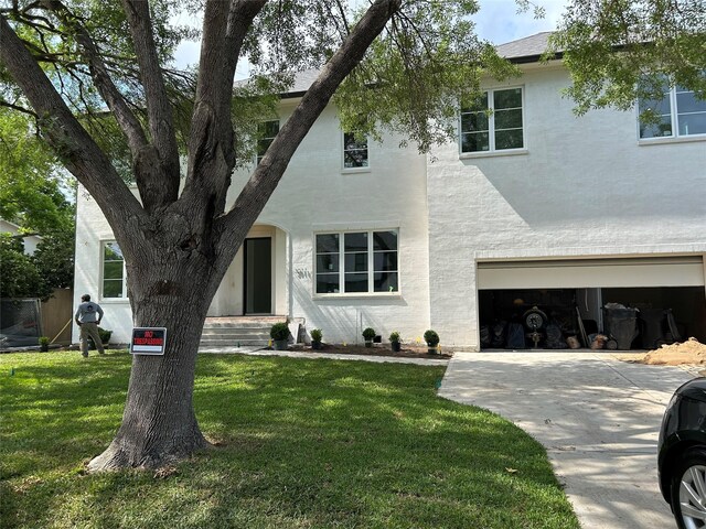 3011 Deal St, Houston, TX 77025 - view of front of house with a front lawn, an attached garage, concrete driveway, and stucco siding