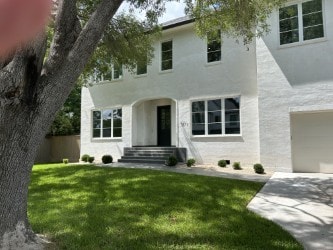 3011 Deal St, Houston, TX 77025 - view of front of property featuring stucco siding, a front lawn, a garage, and concrete driveway