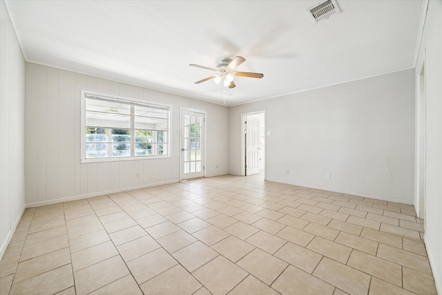 tiled spare room with ceiling fan and ornamental molding