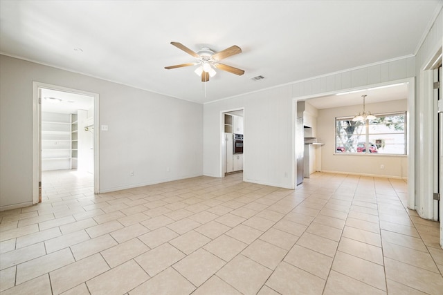 spare room with ceiling fan with notable chandelier, light tile patterned flooring, and crown molding