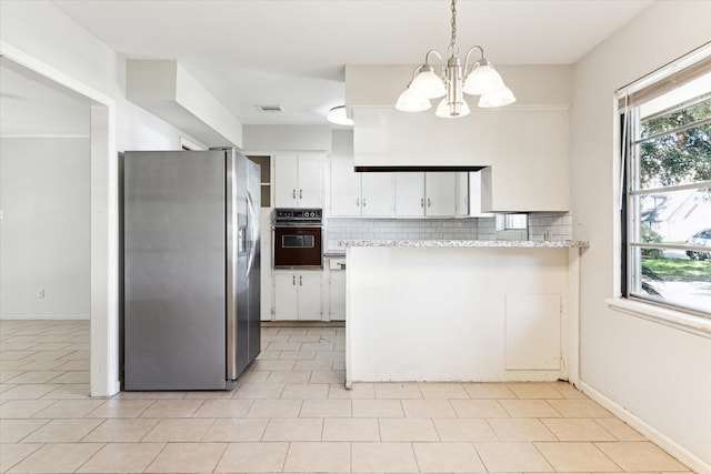 kitchen featuring stainless steel refrigerator with ice dispenser, a notable chandelier, decorative light fixtures, black oven, and white cabinets