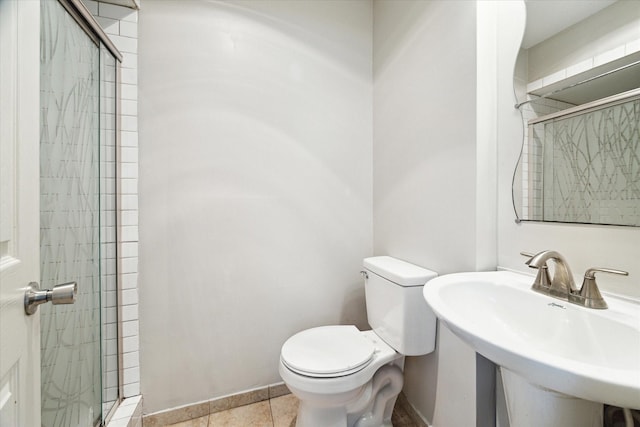 bathroom featuring walk in shower, toilet, sink, and tile patterned flooring