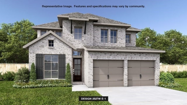 view of front of property featuring a garage and a front lawn