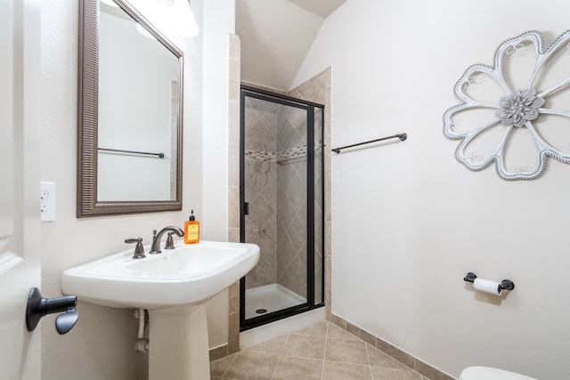 bathroom with lofted ceiling, tile patterned flooring, and an enclosed shower