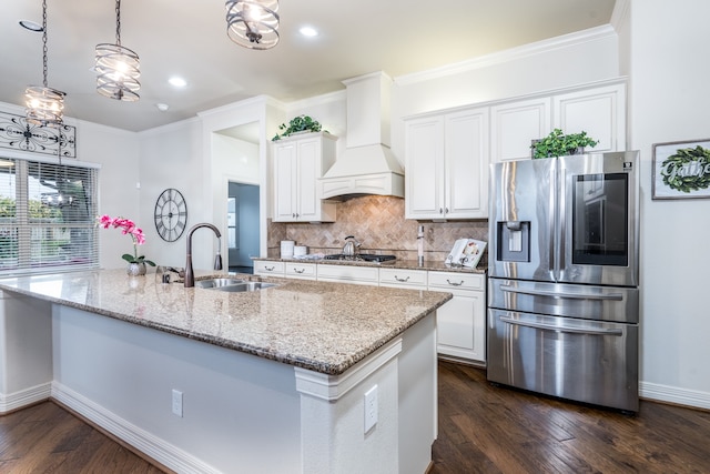 kitchen featuring premium range hood, a center island with sink, stainless steel appliances, white cabinets, and sink