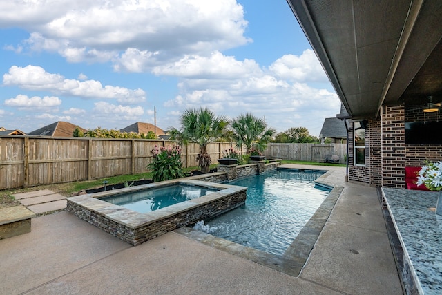 view of pool with pool water feature, a patio, and an in ground hot tub