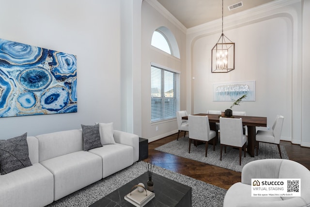 living room with a notable chandelier, dark hardwood / wood-style flooring, and crown molding