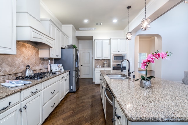 kitchen with sink, white cabinets, a kitchen island with sink, and appliances with stainless steel finishes