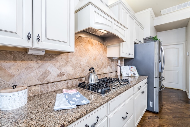 kitchen featuring stainless steel appliances, custom exhaust hood, white cabinets, and light stone counters