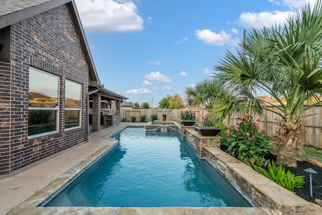 view of swimming pool with an in ground hot tub