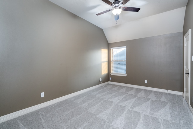 empty room with carpet, vaulted ceiling, and ceiling fan