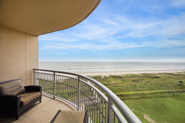 balcony featuring a beach view and a water view