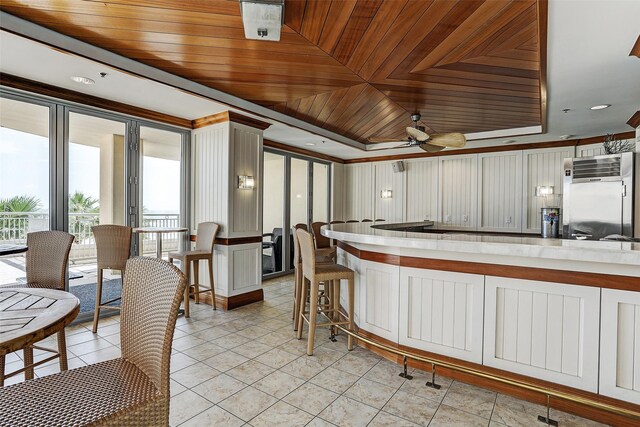 kitchen with light tile patterned floors, plenty of natural light, a ceiling fan, and high end fridge
