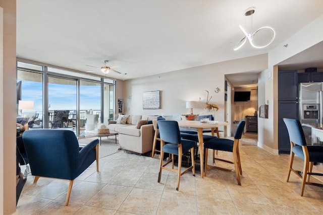 tiled dining area with floor to ceiling windows and ceiling fan