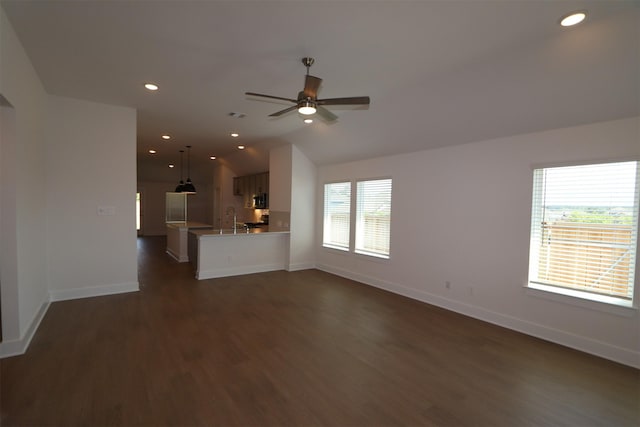 9819 Robard Ridge Ct, Montgomery, TX 77316 - unfurnished living room with dark wood finished floors, a sink, lofted ceiling, and baseboards