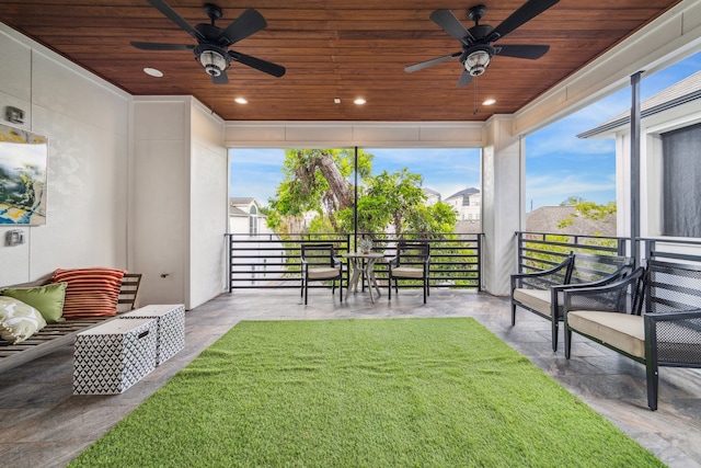 view of yard featuring ceiling fan and a balcony