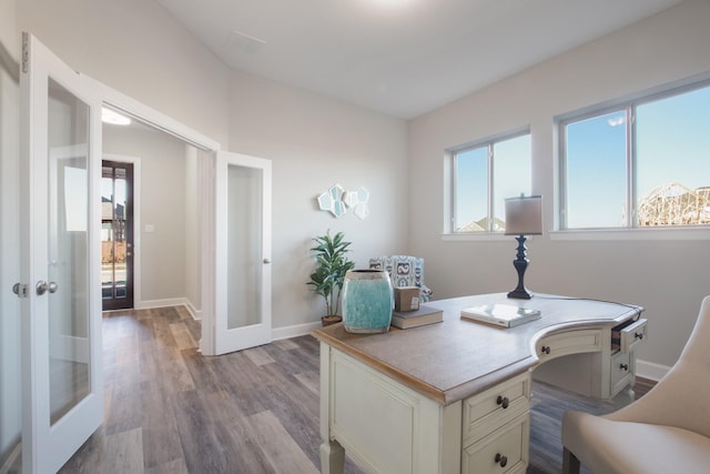 home office with light hardwood / wood-style flooring and french doors