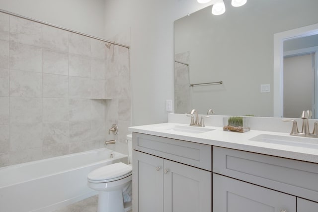 full bathroom featuring vanity, toilet, and tiled shower / bath combo