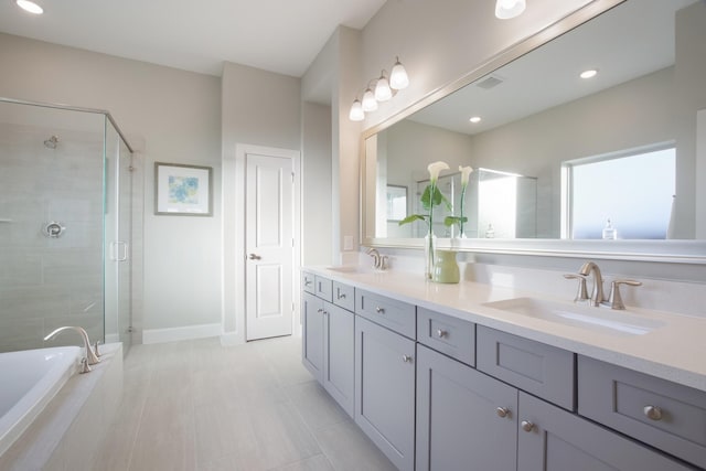 bathroom with vanity and separate shower and tub