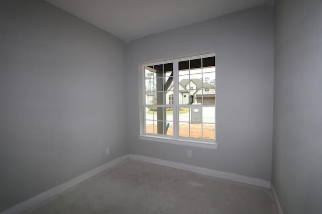 unfurnished room featuring concrete floors