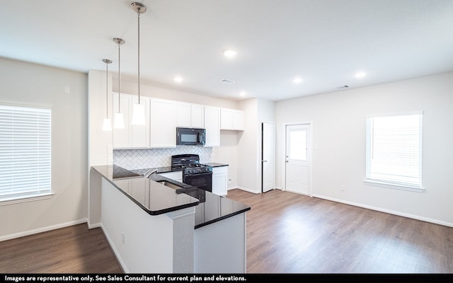 kitchen featuring black appliances, kitchen peninsula, dark hardwood / wood-style floors, hanging light fixtures, and white cabinets