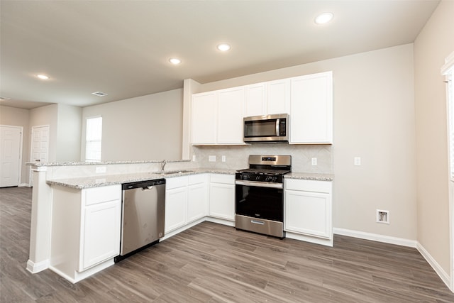 kitchen featuring white cabinetry, light wood-type flooring, and appliances with stainless steel finishes