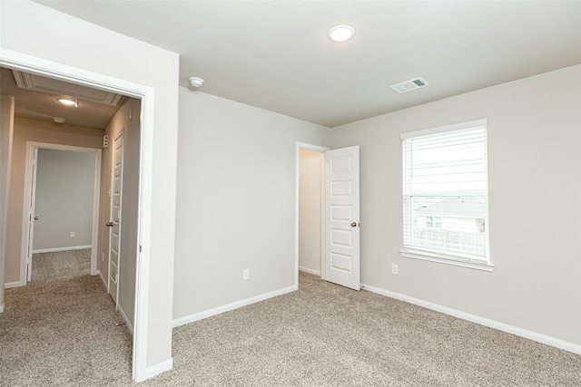 unfurnished room featuring light carpet