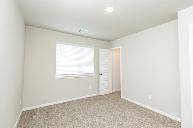 empty room featuring light colored carpet