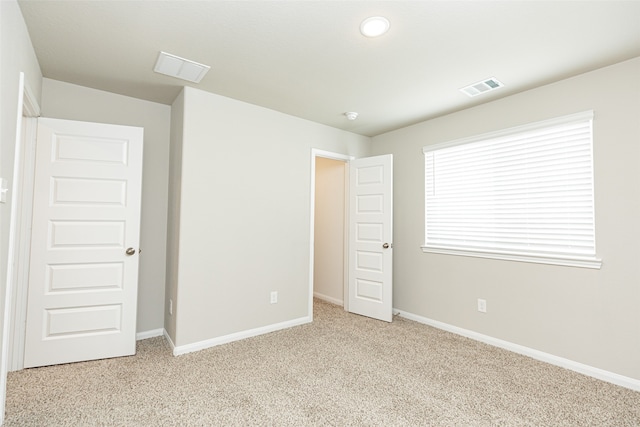 unfurnished bedroom with light carpet