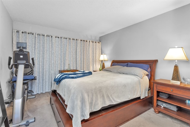 carpeted bedroom featuring a textured ceiling