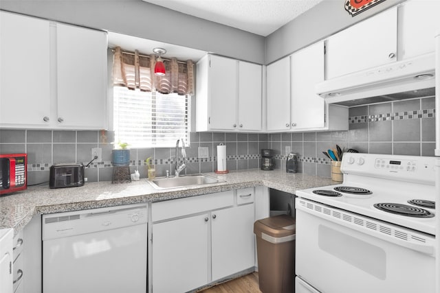 kitchen with white appliances, white cabinetry, sink, and decorative backsplash