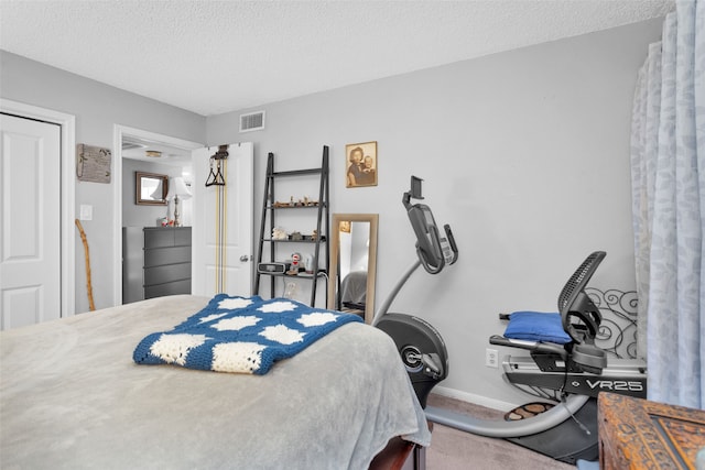 carpeted bedroom with a textured ceiling