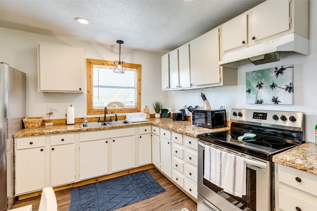 kitchen with white cabinetry, appliances with stainless steel finishes, a textured ceiling, hanging light fixtures, and sink