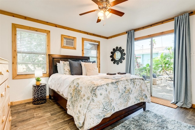 bedroom featuring access to outside, multiple windows, wood-type flooring, and ceiling fan