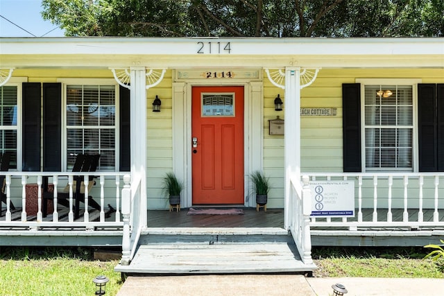 2114 57th St, Galveston, TX 77551 - doorway to property featuring a porch