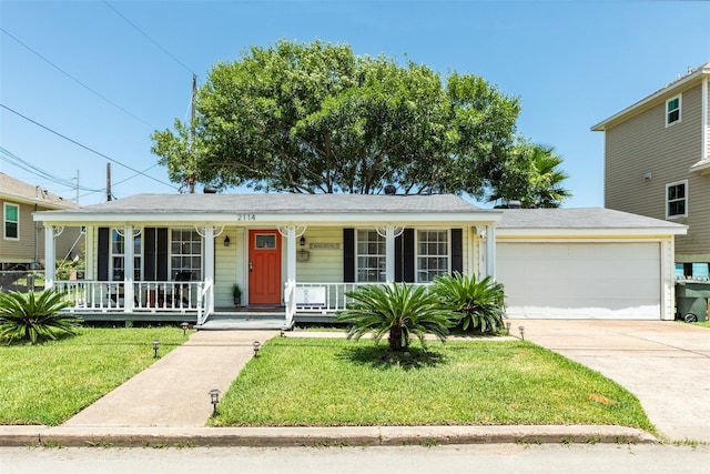 2114 57th St, Galveston, TX 77551 - view of front of house with a porch, a garage, driveway, and a front yard