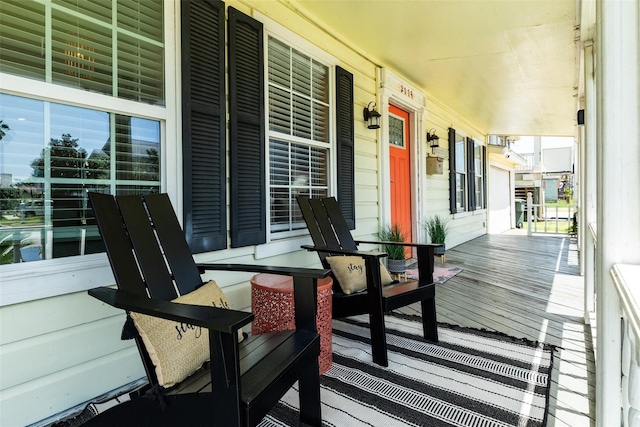 2114 57th St, Galveston, TX 77551 - wooden deck featuring covered porch