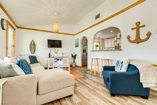 living room featuring light wood-type flooring and lofted ceiling