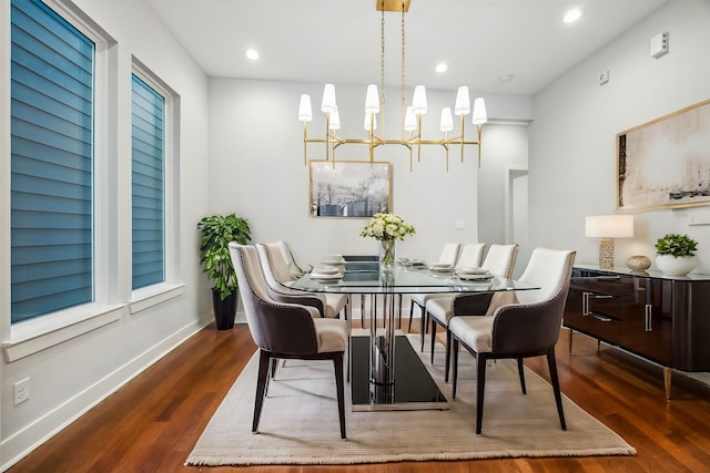 dining space featuring dark hardwood / wood-style floors and a chandelier