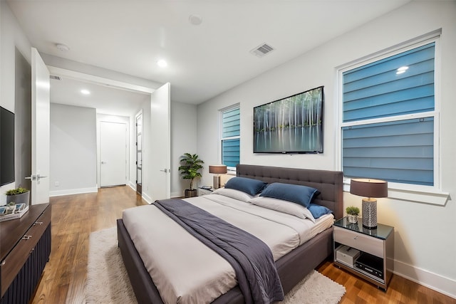 bedroom with dark hardwood / wood-style flooring