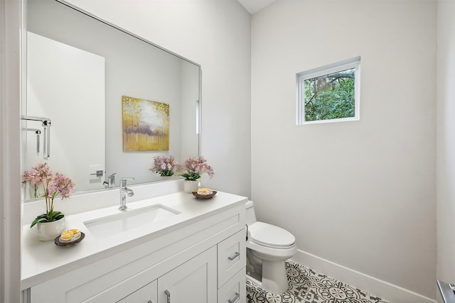 bathroom featuring toilet, vanity, and tile patterned floors