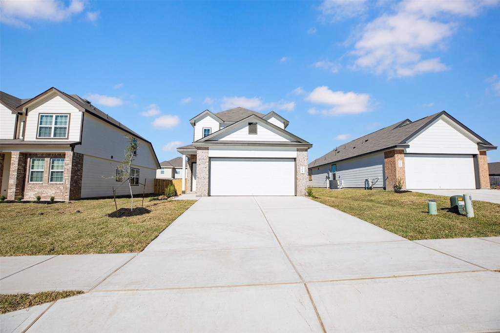 view of front of house with a garage and a front lawn