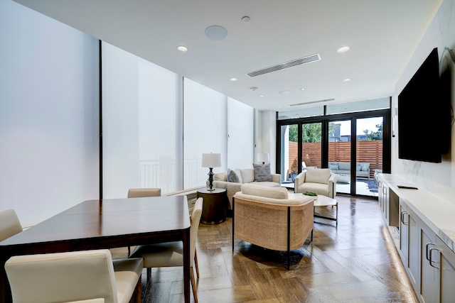 living room with light parquet floors and floor to ceiling windows