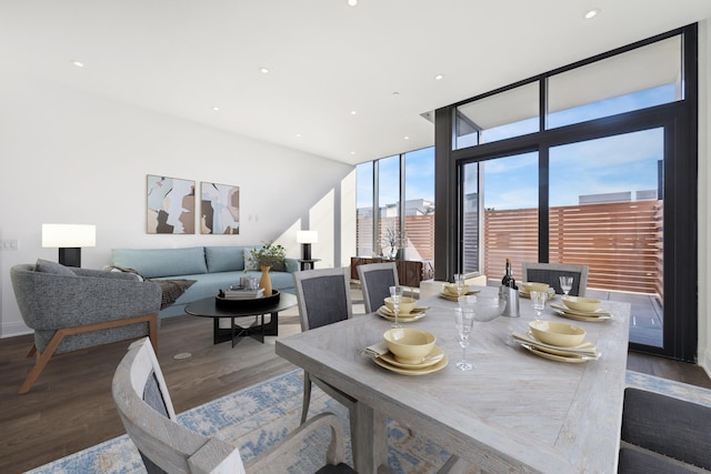 dining room featuring expansive windows and dark hardwood / wood-style flooring