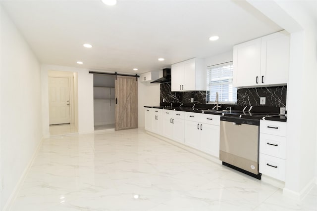 kitchen featuring a barn door, dishwasher, and white cabinets