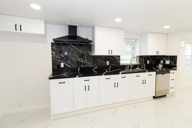 kitchen with dishwasher, decorative backsplash, wall chimney exhaust hood, and sink